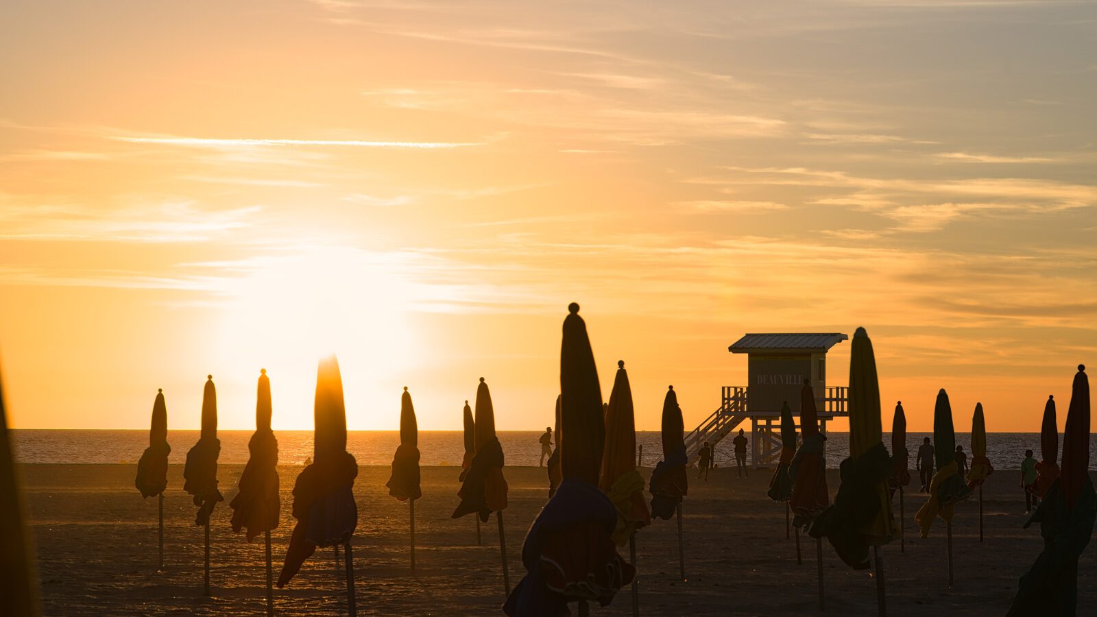 Sunset behind the parasols of Deauville in Normandy